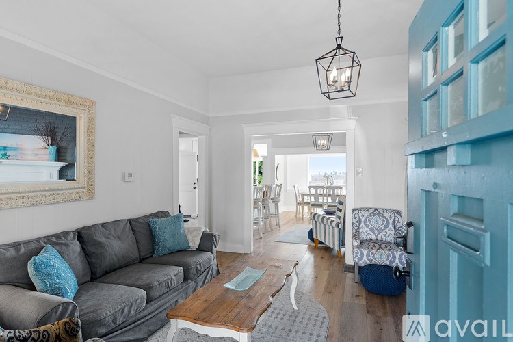 A living room with a grey couch and a wooden coffee table.