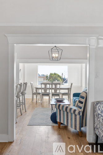 A dining room with a table set for six and a view of the city.