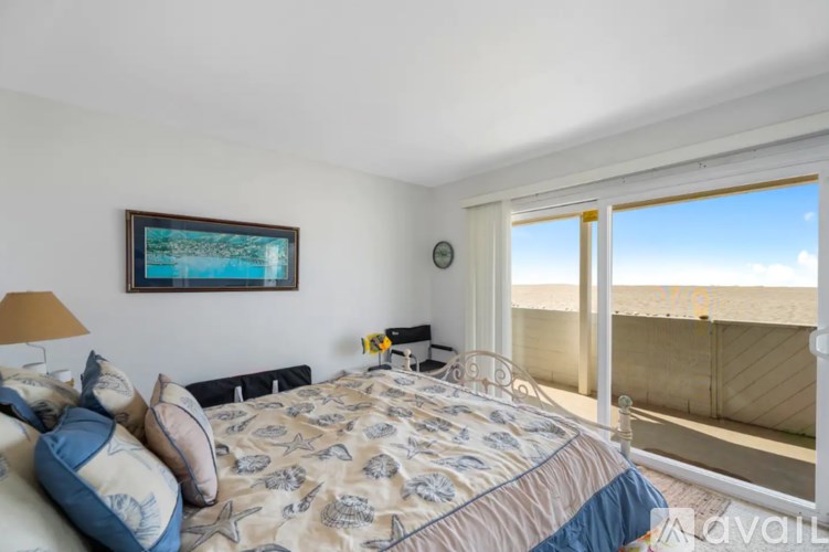 A bedroom with a large bed and a painting on the wall.