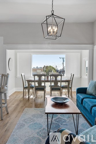 A modern dining room with a wooden table and chairs.