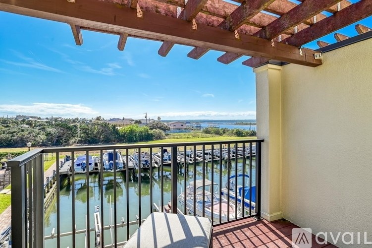 A balcony with a view of a marina and boats.