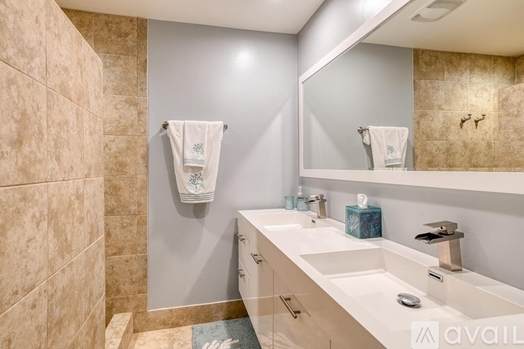 A bathroom with a white sink and a mirror.