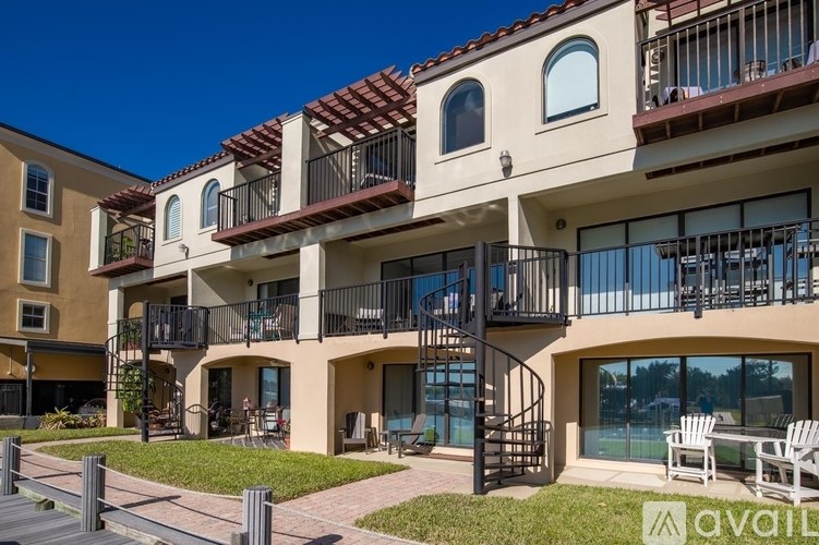 Apartment complex with a sign that says "available" in the foreground.