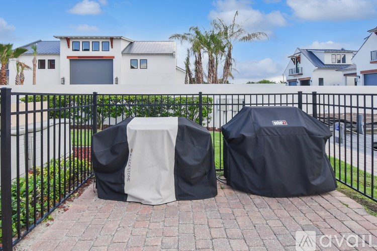 Two grills are covered with black and white covers.