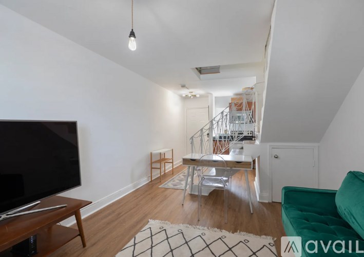 A living room with a television, a chair, and a table.