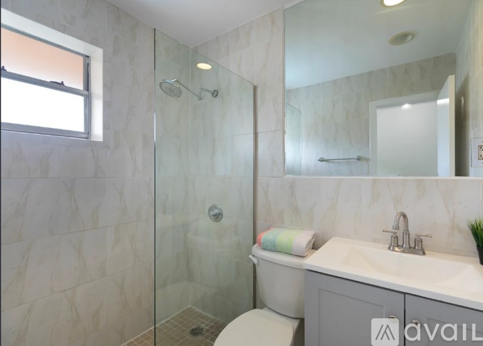 A bathroom with a toilet, sink, and shower.