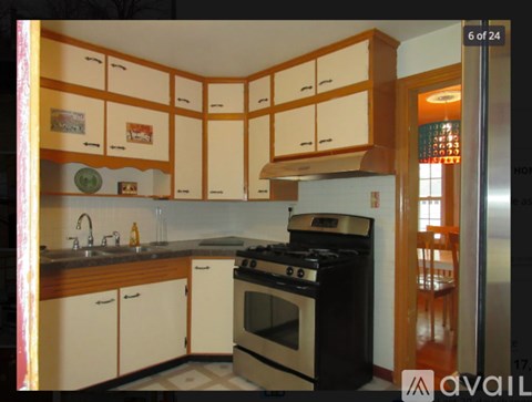 A kitchen with white cabinets and a black stove top oven.