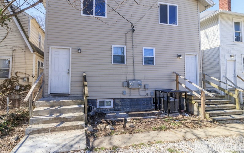 A house with a grey siding and a white door.
