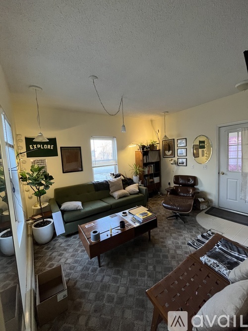 A living room with a green couch, a wooden coffee table, and a sign that says "Explore".