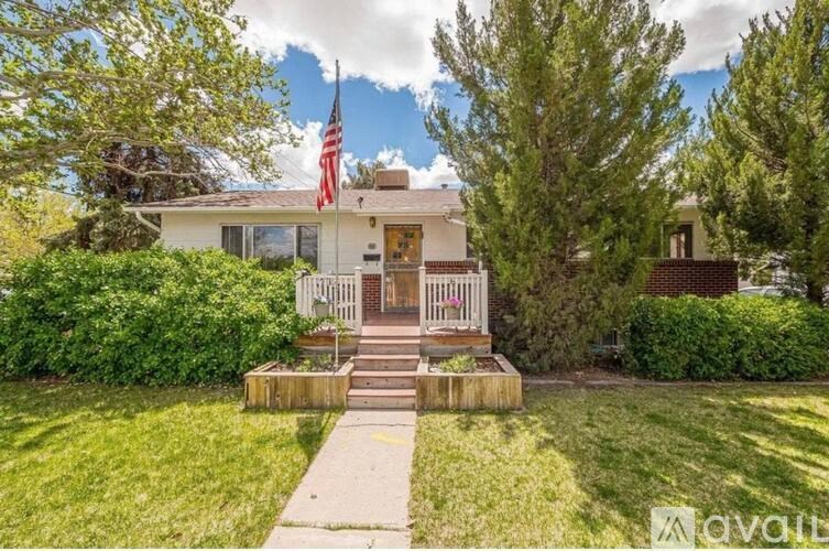 A house with a flag on the front porch is for sale.