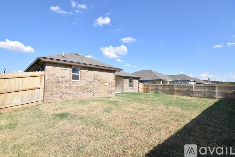 A house with a fence and a grassy yard is for sale.