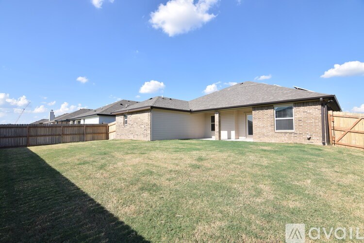 A house with a fence and a yard is for sale.