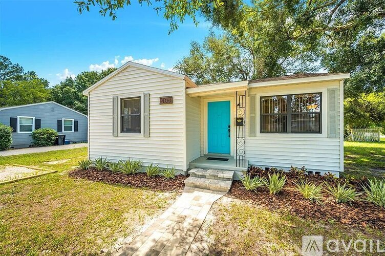 A small house with a blue door is for sale.