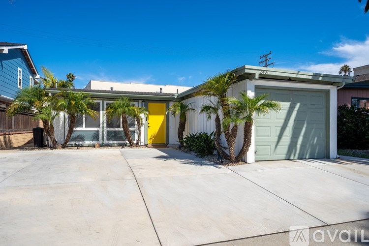 A house with a yellow door and a garage.