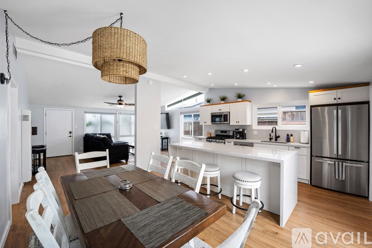 A modern kitchen with a dining table and chairs.