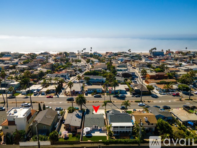 A red arrow points to a house in a residential area.
