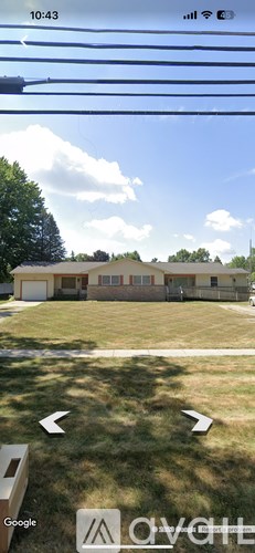 A house with a white fence and a green lawn.