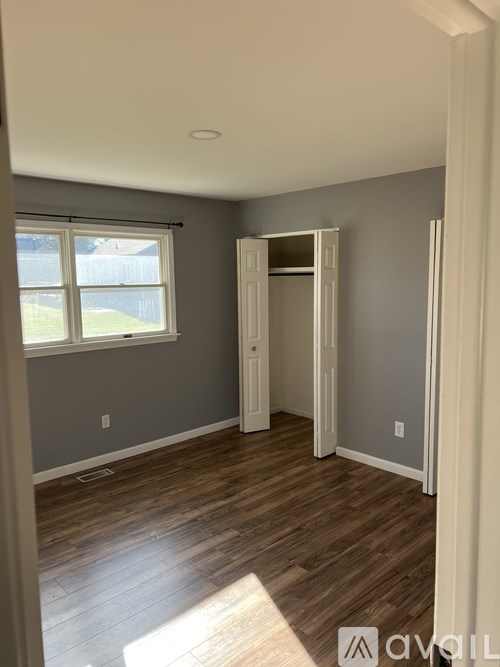 A room with wooden floors and a white door.