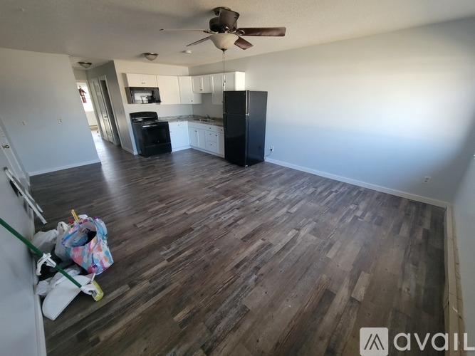 A room with wooden flooring and a ceiling fan.