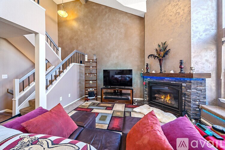 A living room with a fireplace and a couch.