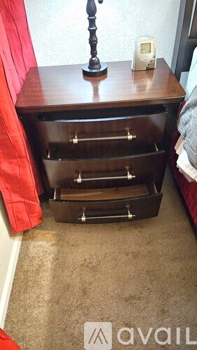 A wooden table with a drawer and a small box on top of it.
