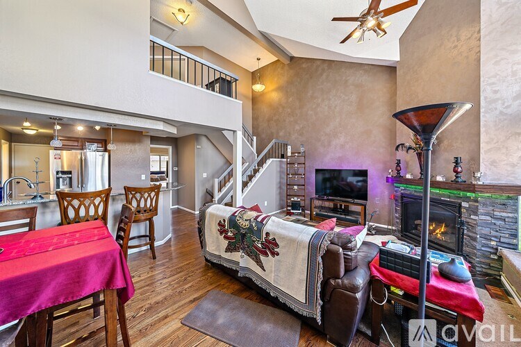 A living room with a couch, a table, and a television.