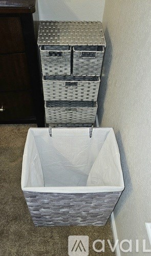 A stack of three baskets with the largest one open and hanging from a hook.