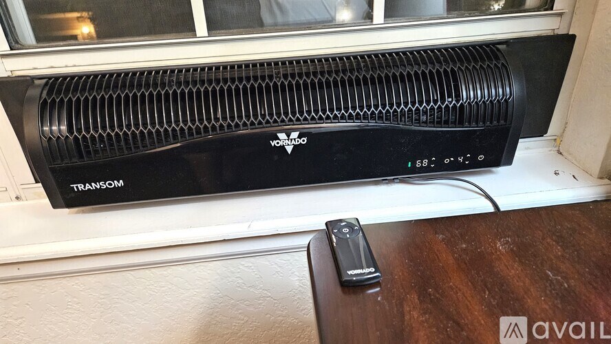 A YOSEMITE brand air conditioner unit sits on a windowsill.