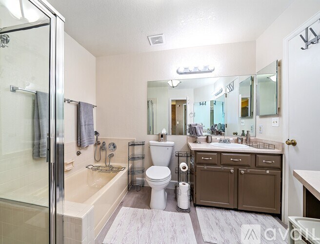 A bathroom with a toilet, sink, and shower.