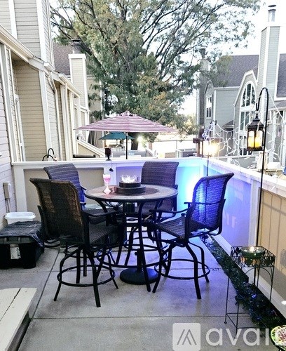 A patio with a table and chairs is set up.
