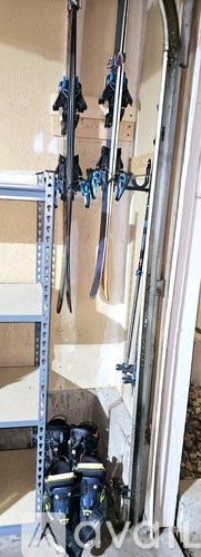 A pair of blue shoes are hanging on a rack.