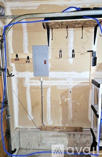 A bathroom under construction with pipes and drywall.