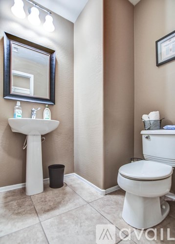 A bathroom with a white toilet and sink.