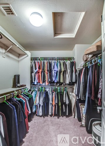 A room with a lot of clothes hanging up.