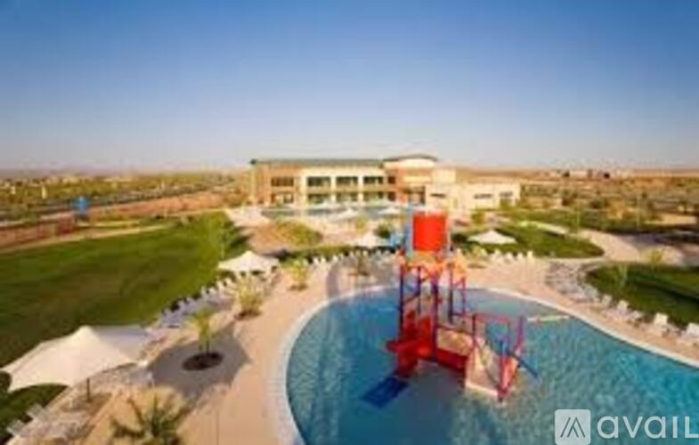A large building with a pool in front of it.
