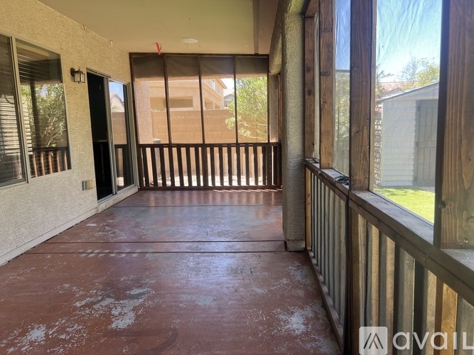 A patio with a red floor and wooden railings.