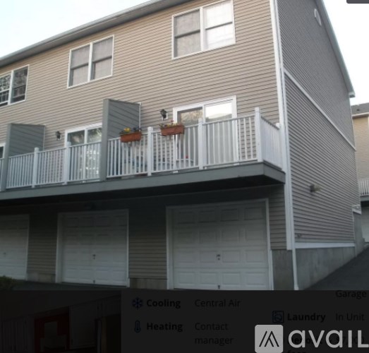 A two-story apartment building with a balcony and a sign that says "available".