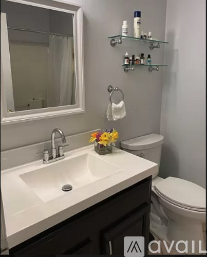 A bathroom with a white sink and a white toilet.