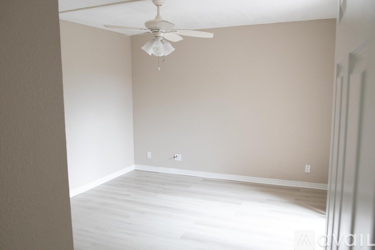 A room with a ceiling fan and light fixture.