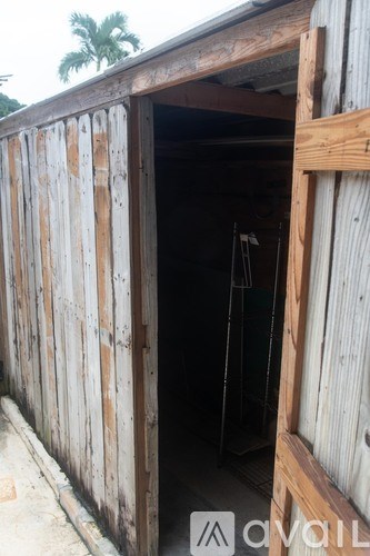 A wooden shed with a door open.