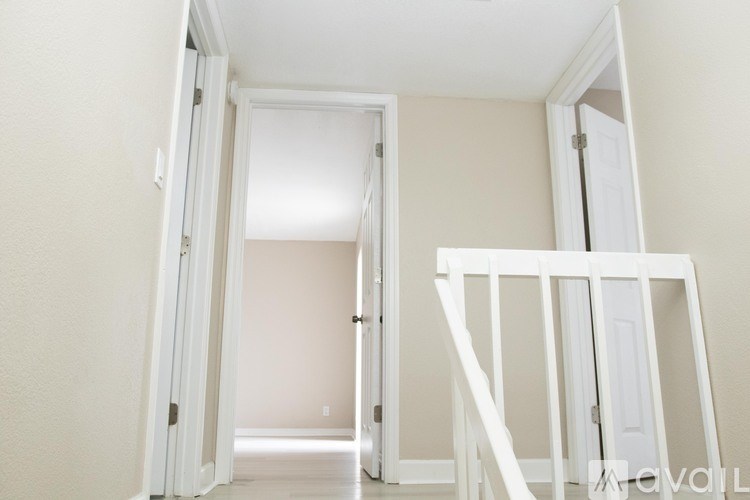A room with a white door and a white wall.