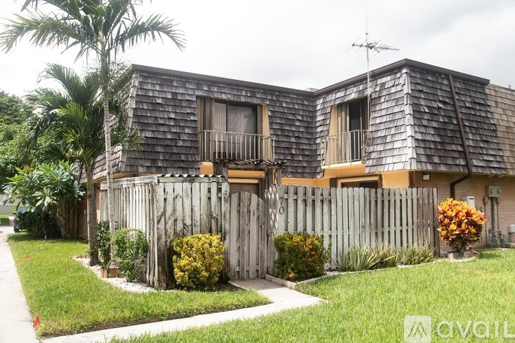 A house with a wooden fence and a balcony.