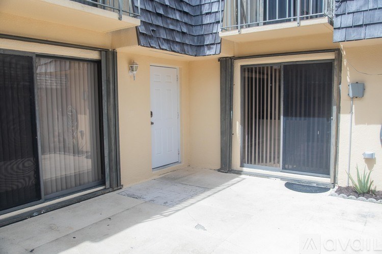 A white door is on the right side of a building.