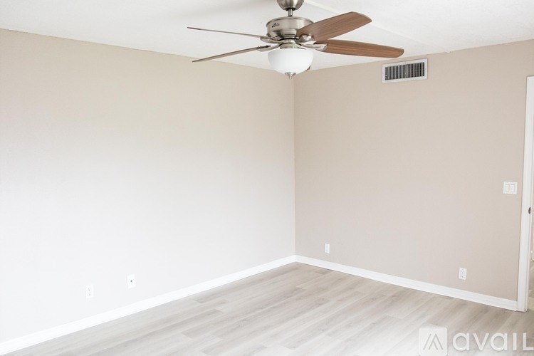 A room with a ceiling fan and light fixture.