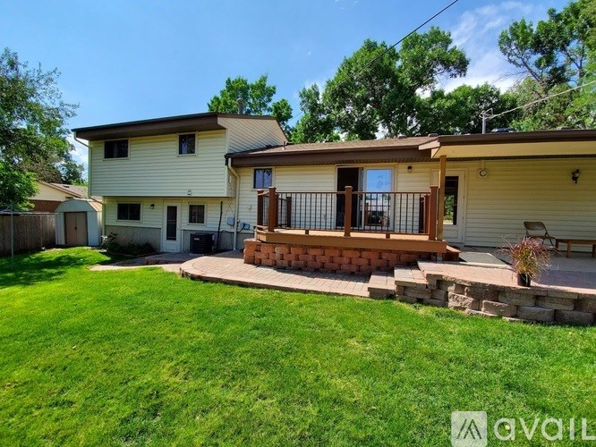 A house with a well-maintained lawn and a deck.