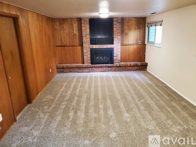 A living room with a fireplace and a flat screen TV.