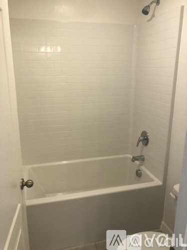 A white bathroom with a tub and shower.