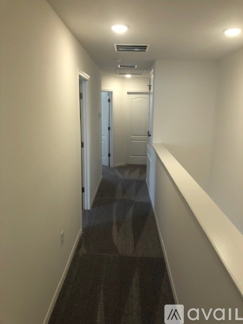 A long hallway with doors at the end.