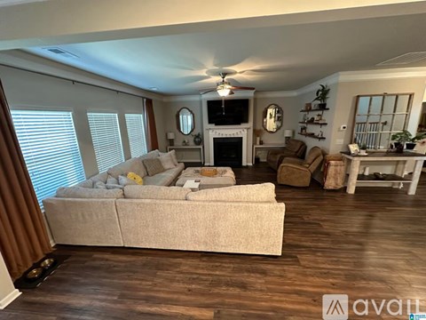 A living room with a white couch and a television.