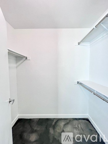 A white wall with a sliding door and a sliding shelf.